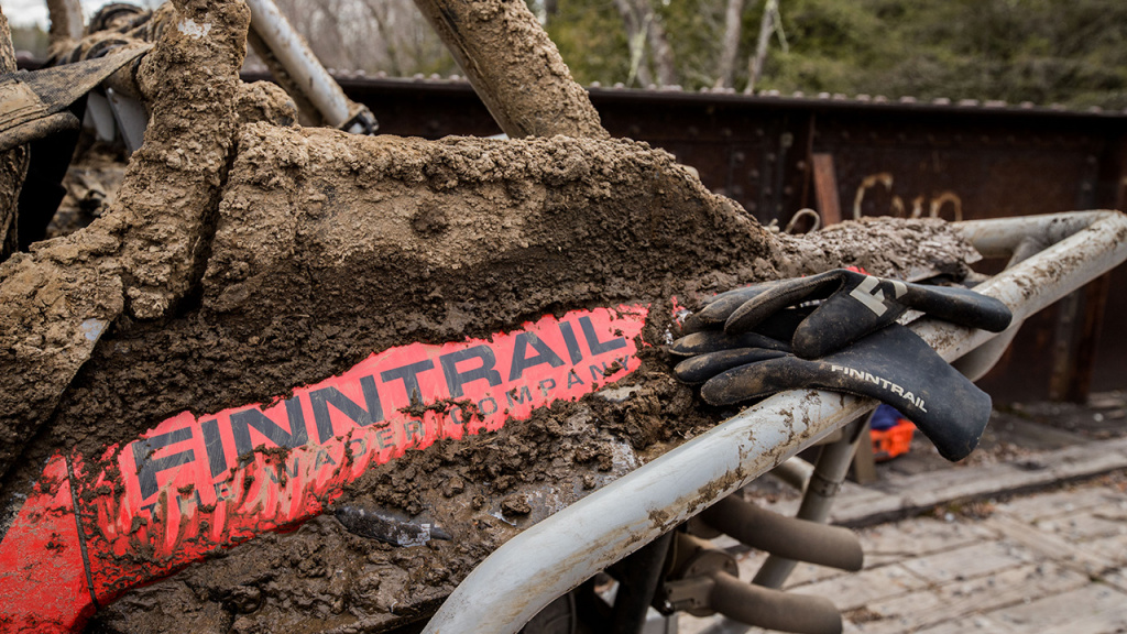 atv and neoprene off-road gloves in mud