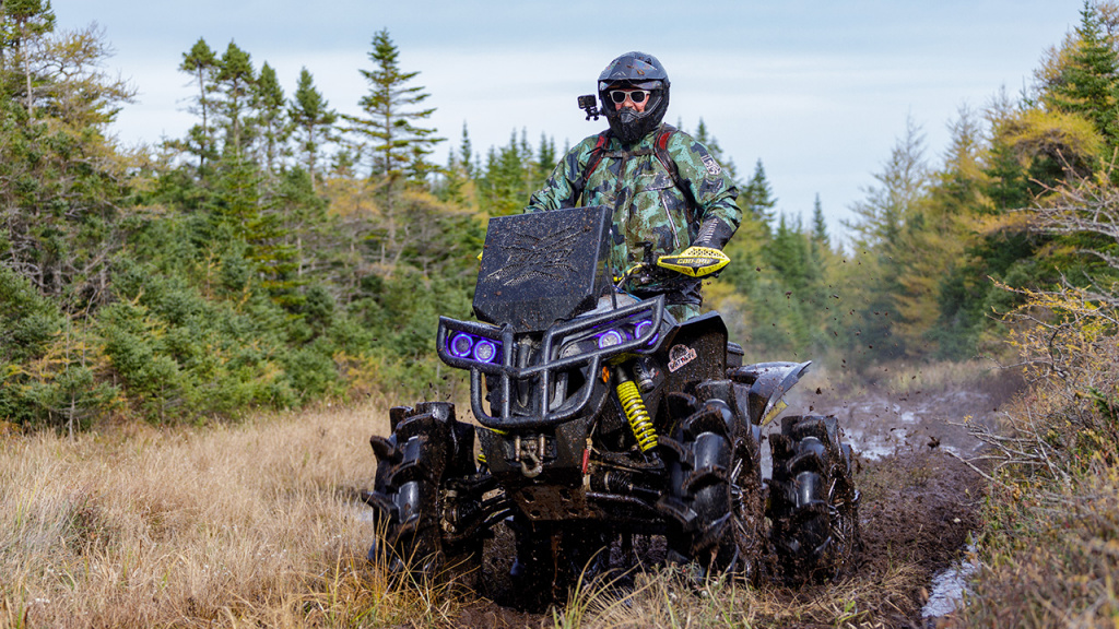 man atv riding in muskeg