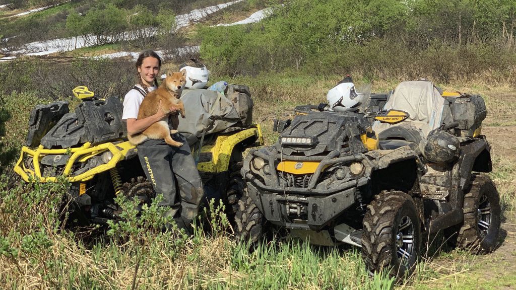 girl with dog near atv