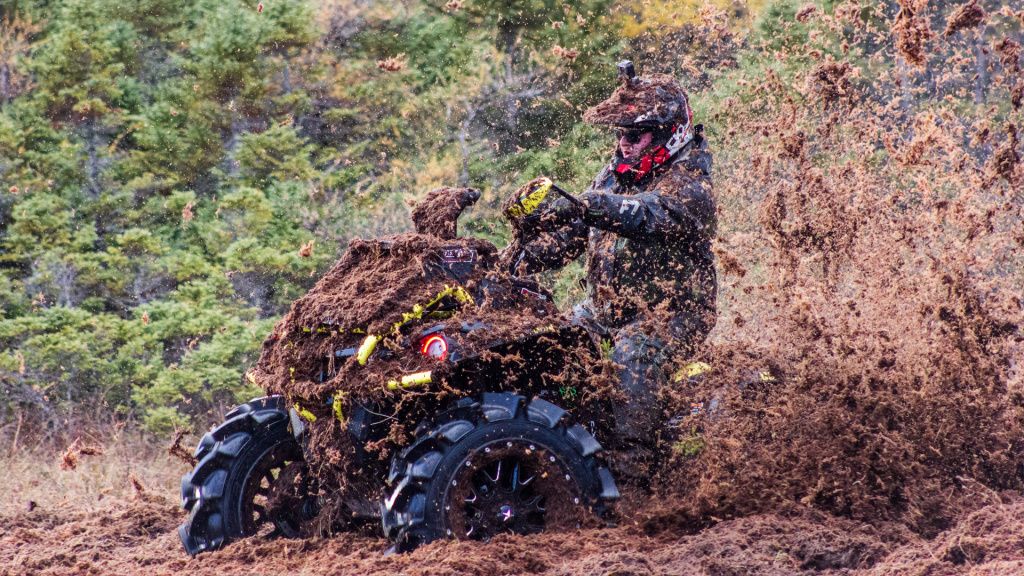 A man on ATV in the mud