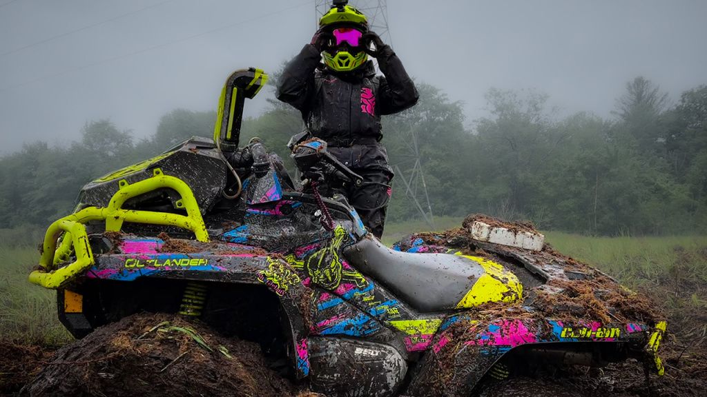 atv in mud girl rider in goggles 