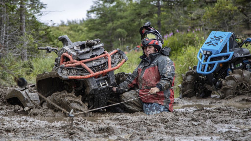 man with winch in mud