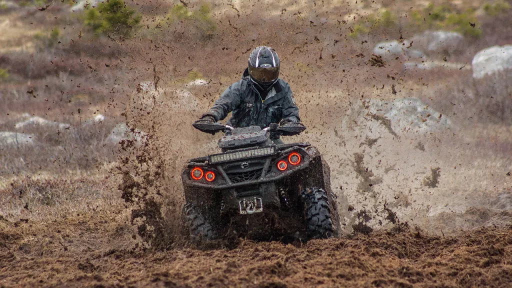 atv riding hard in mud
