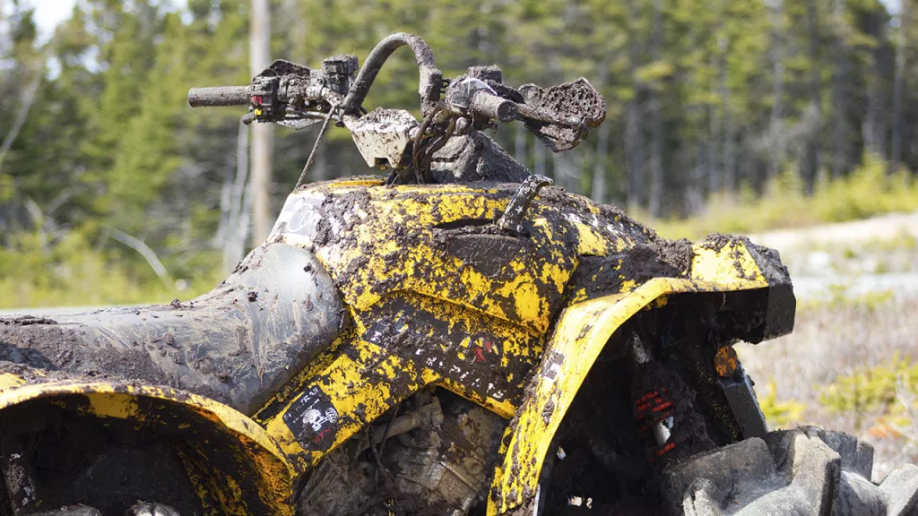 atv in mud with bent handle bar