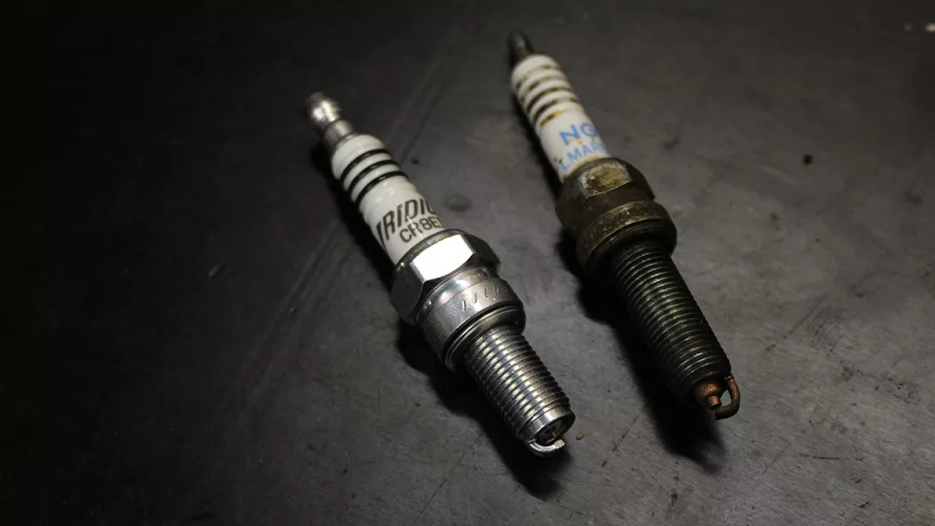 new and fouled spark plugs