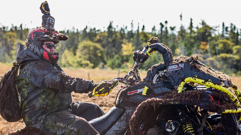 man riding atv holding hand on handlebar grips man riding atv holding hand on handlebar grips